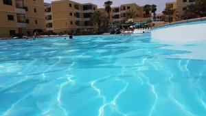 
a swimming pool filled with lots of blue water at Apartamento Pepe in Playa del Ingles
