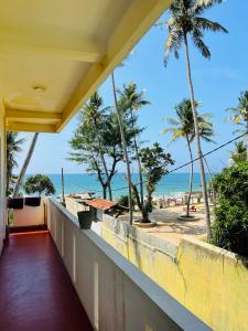 a balcony with a view of the beach at Hotel Meer in Ambalangoda