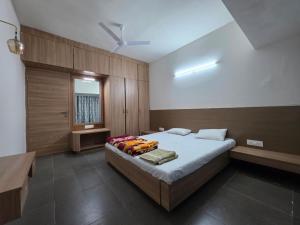a bedroom with a bed and a ceiling fan at Kimaya Cottage - 2BHK 1 Washroom in Trimbak