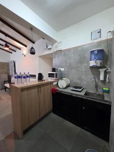 a kitchen with a sink and a counter with a sink at Kimaya Cottage - 2BHK 1 Washroom in Trimbak