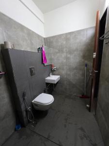 a bathroom with a toilet and a sink at Kimaya Cottage - 2BHK 1 Washroom in Trimbak +15 photos
