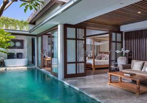 a swimming pool in a villa with a living room at Goya Boutique Resort in Ubud