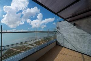 a balcony with a view of the ocean at Brown Dot Hotel Siheung Geobukseom in Siheung