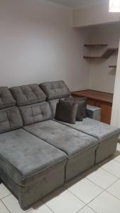 a large couch sitting in a living room at Apartamento suite central 72 in Franca