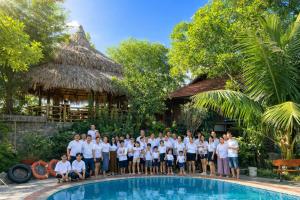 a group of people standing next to a swimming pool at Trang An Lighthouse Homestay in Ninh Binh