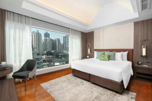 a bedroom with a large bed and a large window at Hotel Mermaid Bangkok in Bangkok +86 photos