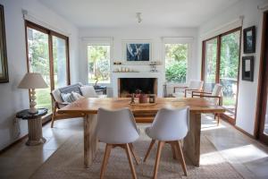 a living room with a wooden table and chairs at Casa Nopal in Punta del Este +10 photos