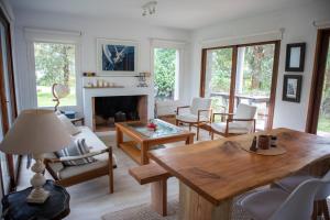 a living room with a table and a fireplace at Casa Nopal in Punta del Este