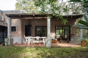 a patio with a table and chairs at Casa Nopal in Punta del Este