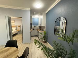 a living room with a dining table and a kitchen at The Marley in Polokwane