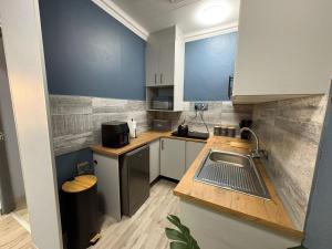a small kitchen with a sink and a counter at The Marley in Polokwane +8 photos