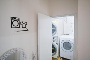 a laundry room with a washer and dryer at Casa Blanca Guesthouse in Nagasaki