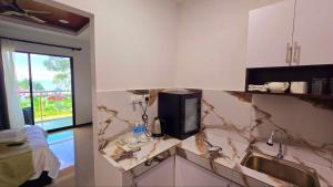 a kitchen with marble counter tops and a sink at Badungun Seaside View in Kuala Penyu +60 photos