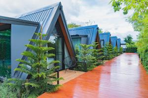 a row of blue houses with a wooden floor at The View A-Frame Cabin in Chiang Dao