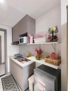 a small kitchen with a sink and a microwave at Arc Tower Cebu 1714 in Cebu City