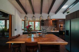 a kitchen with a wooden table in a room at Casa Tutuli in Coajomulco
