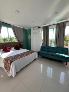 a bedroom with a bed and a couch and windows at Yopo Resort in Yopal +12 photos