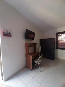 a room with a desk and a chair and a television at Nice apartment in the north in Hermosillo