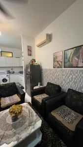 a living room with two couches and a kitchen at SKS Pavillion Residences - High Floor with Singapore View in Johor Bahru