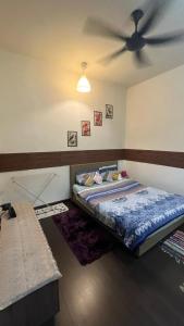 a bedroom with a bed with a ceiling fan at SKS Pavillion Residences - High Floor with Singapore View in Johor Bahru +74 photos