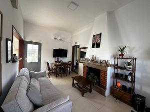 a living room with a couch and a fireplace at Casa independiente con estufa a leña in Minas