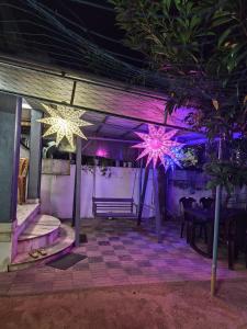 a room with purple and pink lights on the ceiling at Agapi Homestay in Cochin