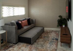 a living room with a couch and a table at Casa Consulado Creta in Manuel F. Martínez