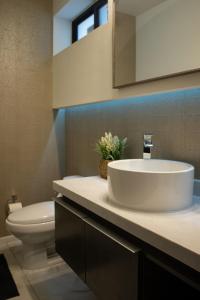 a bathroom with a sink and a toilet at Casa Consulado Creta in Manuel F. Martínez +12 photos