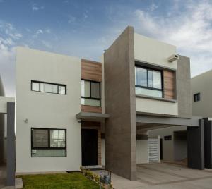a modern house with white walls and windows at Casa Consulado Creta in Manuel F. Martínez