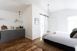 a bedroom with a large bed and a kitchen at King Bed Studio in the Heart of Richmond in Richmond