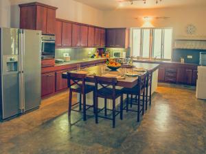 a kitchen with a large island with a table with chairs at The Lagoon Villa in Negombo