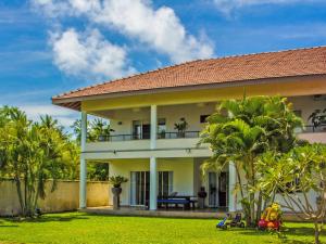 a house with a balcony and a yard at The Lagoon Villa in Negombo