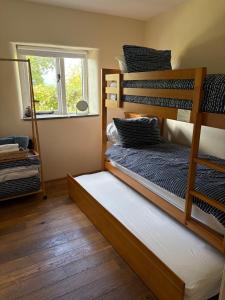 two bunk beds in a room with a window at Long Barn Wales in Monmouth +14 photos