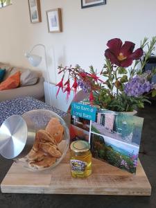 a table with a plate of food on a cutting board at Long Barn Wales in Monmouth