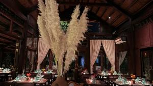 a dining room with tables and chairs with a large centerpiece at La Lua Resort Ninh Binh in Ninh Binh +102 photos