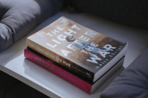two books sitting on top of a table at Tallarook Hilltop Tiny House 1 by Tiny Away in Tallarook