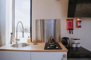 a kitchen with a sink and a counter top at Tallarook Hilltop Tiny House 1 by Tiny Away in Tallarook