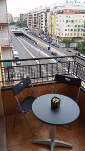 una mesa y 2 sillas en un balcón con una autopista en Pasarela Apartment, en Valencia