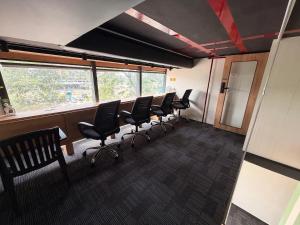 a waiting room with a row of chairs in an office at Nap Junction in Pune