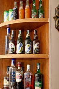 a shelf filled with lots of bottles of alcohol at Hotel Maheshwor in Pashupatināth
