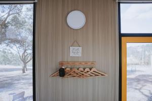 a door with a rack of wooden logs at Tallarook Hilltop Tiny House 3 by Tiny Away in Tallarook