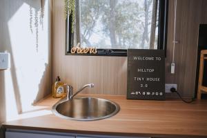 a sink in a kitchen next to a window at Tallarook Hilltop Tiny House 3 by Tiny Away in Tallarook +13 photos