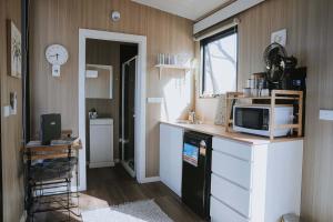 a kitchen with a counter with a microwave and a microwave at Tallarook Hilltop Tiny House 3 by Tiny Away in Tallarook