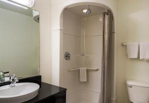 a bathroom with a shower with a sink and a toilet at Motel 6-Laramie, WY in Laramie +53 photos