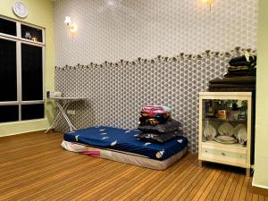 a room with a bed in the middle of a room at Azihar Homestay Marang in Marang