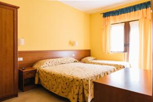 Rúm í herbergi á Hotel Nilde