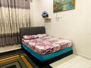 a small bedroom with a bed in a room at Azihar Homestay Marang in Marang