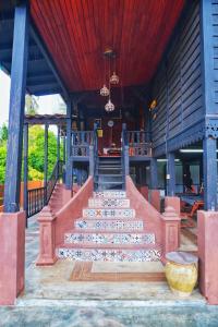 a set of stairs leading to a building at Pondok Panglima Awang in Pantai Cenang