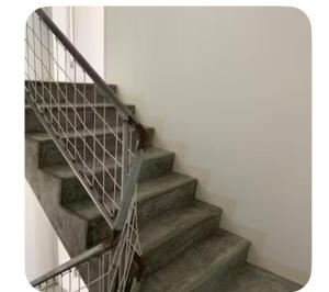a set of stairs with a metal railing at Central studio Nomad friendly 1B in Mindelo
