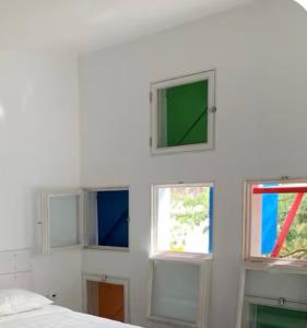 a room with four windows in a white wall at Central studio Nomad friendly 1B in Mindelo
